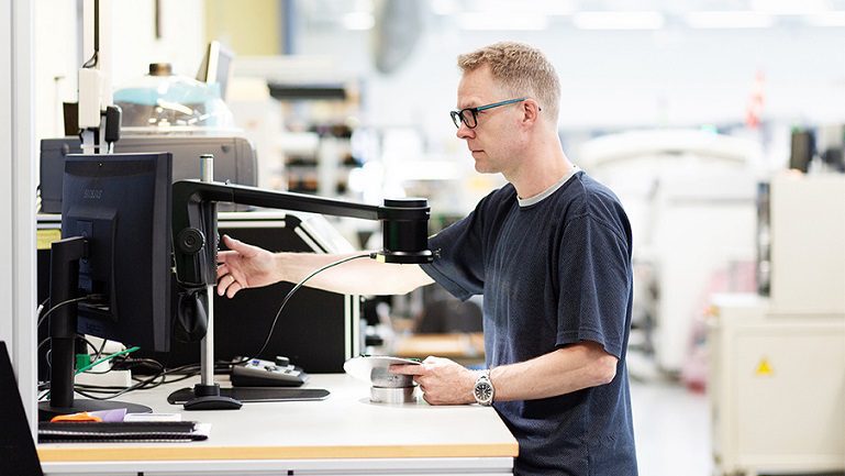 Operator adjusting digital microscope using 1080p progressive scan