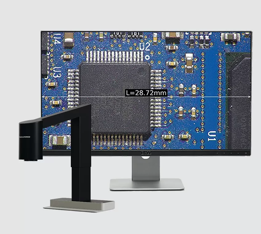 Digital microscope next to a monitor with a magnified PCBA